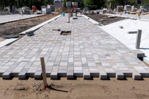 View of a construction site with gray rectangular paving stones