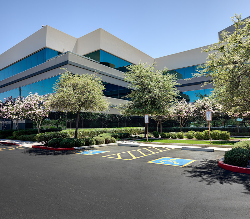 A office building against a blue sky.